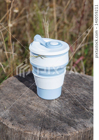 Empty blue-white foldable silicone mug 140059211