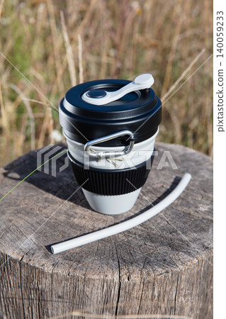 Eco-friendly folding cup stands on a wooden stump 140059233