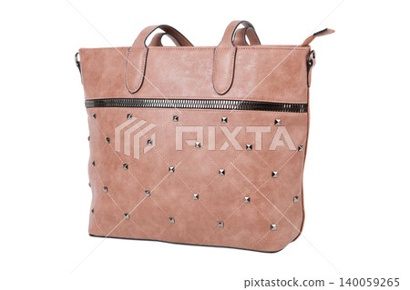 Beige quilted leather tote bag with metallic studs isolated on white background. Side view of a female shopper handbag with diamond pattern embroidery. Beige quilted leather tote bag with metallic studs isolated on white background. Side view of a female shopper handbag with diamond pattern embroidery. 140059265