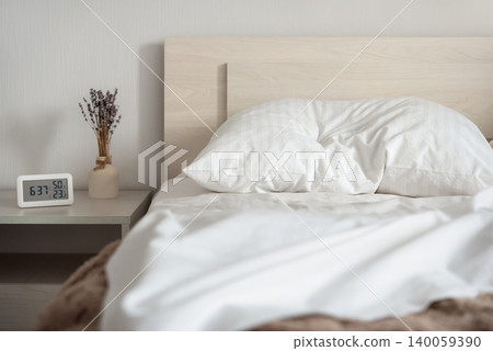 Bedroom interior with digital thermometer and hygrometer on bedside table Bedroom interior with digital thermometer and hygrometer on bedside table 140059390