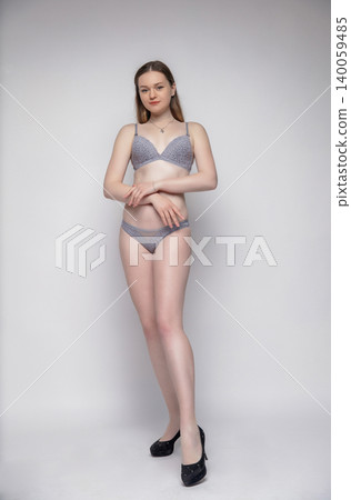 Beautiful woman dressed in grey lingerie Beautiful woman dressed in grey lingerie 140059485