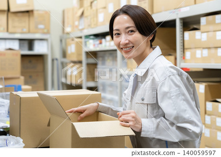 Middle-aged female worker in a warehouse Middle-aged female worker in a warehouse 140059597