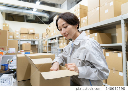 Middle-aged female worker in a warehouse Middle-aged female worker in a warehouse 140059598