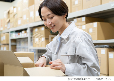 Middle-aged female worker in a warehouse Middle-aged female worker in a warehouse 140059599