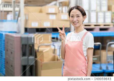 Middle-aged female worker in a warehouse Middle-aged female worker in a warehouse 140059643