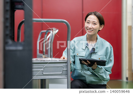 Middle-aged female worker in a warehouse Middle-aged female worker in a warehouse 140059646