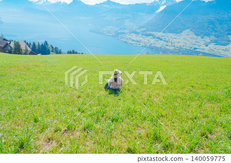 A woman overlooking Lake Lucerne from a hilltop. A woman overlooking Lake Lucerne from a hilltop. 140059775