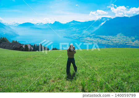 A woman overlooking Lake Lucerne from a hilltop. A woman overlooking Lake Lucerne from a hilltop. 140059799