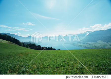 A woman overlooking Lake Lucerne from a hilltop. 140059812