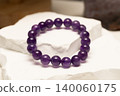 Natural stone bracelet made of amethyst on white surface 140060175