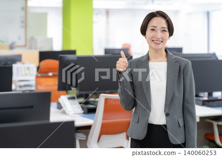 A middle-aged businesswoman working in an office A middle-aged businesswoman working in an office 140060253