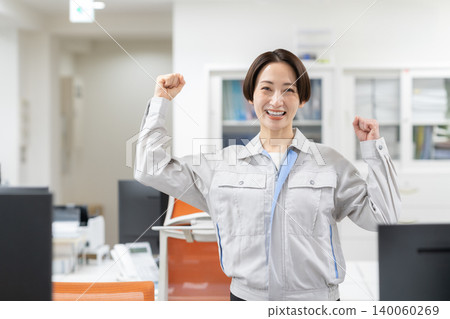 Middle-aged female engineer in work clothes at the office Middle-aged female engineer in work clothes at the office 140060269
