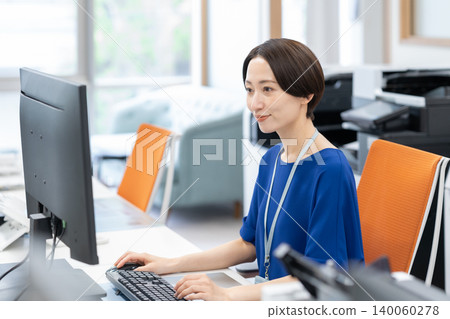 A middle-aged businesswoman working in an office A middle-aged businesswoman working in an office 140060278