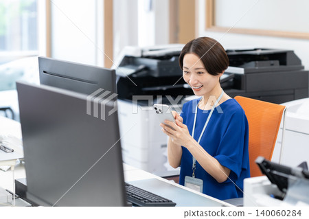 A middle-aged businesswoman working in an office A middle-aged businesswoman working in an office 140060284
