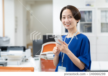 A middle-aged businesswoman working in an office A middle-aged businesswoman working in an office 140060299
