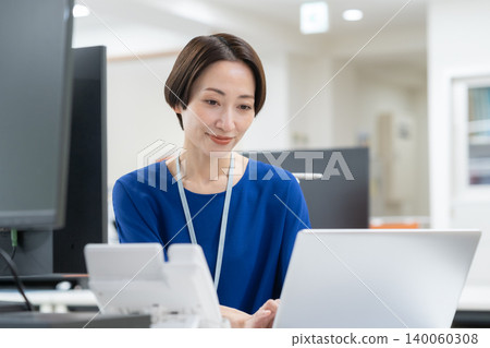 A middle-aged businesswoman working in an office A middle-aged businesswoman working in an office 140060308