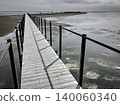 Colors that capture the drama of the Earth: Beautiful green algae and a promenade spread across the water's surface of a desolate sand spit. 140060340