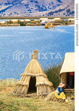 PERU - MAY 11, 2015: Unidentified women in traditional dresses welcome tourists in Uros Island 140060809