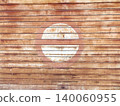 Faded circular logo on weathered wood. 140060955