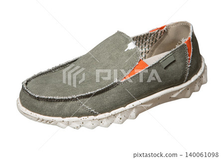 Men's khaki canvas slip-on shoe with orange accents isolated on white background, side view. Modern casual textile loafer with speckled rubber sole for summer streetwear Men's khaki canvas slip-on shoe with orange accents isolated on white background, side view. Modern casual textile loafer with speckled rubber sole for summer streetwear 140061098