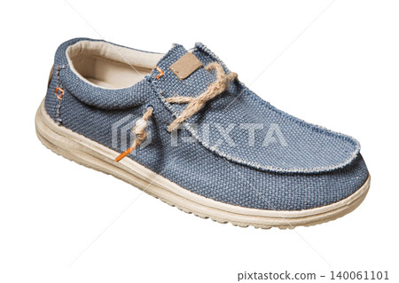 Men's blue canvas boat shoe with jute rope laces isolated on white background, side view. Casual male textile loafer with rustic burlap texture and beige sole Men's blue canvas boat shoe with jute rope laces isolated on white background, side view. Casual male textile loafer with rustic burlap texture and beige sole 140061101