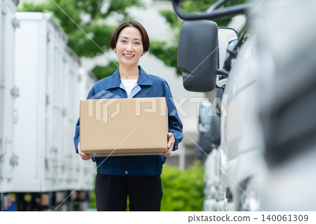 Middle-aged truck driver carrying luggage Middle-aged truck driver carrying luggage 140061309