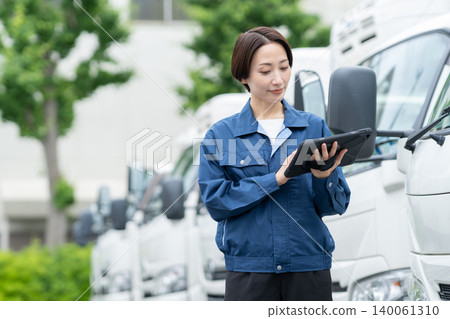 Middle-aged truck driver carrying luggage Middle-aged truck driver carrying luggage 140061310