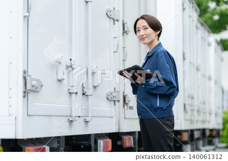 Middle-aged truck driver carrying luggage Middle-aged truck driver carrying luggage 140061312