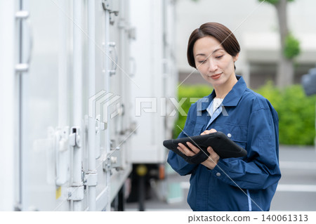 Middle-aged truck driver carrying luggage Middle-aged truck driver carrying luggage 140061313