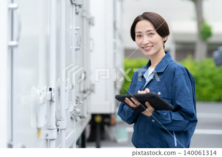 Middle-aged truck driver carrying luggage Middle-aged truck driver carrying luggage 140061314