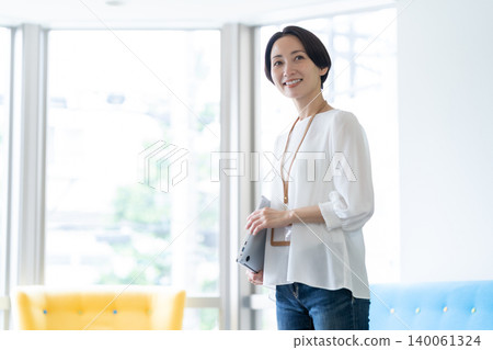 Middle-aged female engineers working in an office Middle-aged female engineers working in an office 140061324