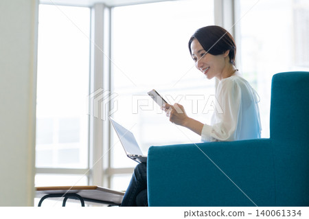 Middle-aged female engineers working in an office Middle-aged female engineers working in an office 140061334