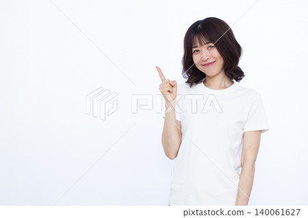 A woman who raises her index finger with a smile A woman who raises her index finger with a smile 140061627