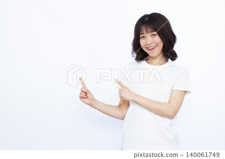 A woman who raises her index finger with a smile A woman who raises her index finger with a smile 140061749