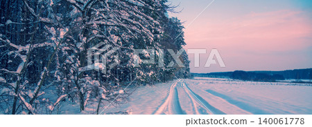 Winter landscape. Road covered with snow along forest Winter landscape. Road covered with snow along forest 140061778