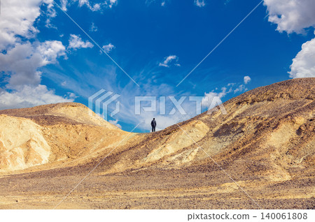 Desert landscape. Man standing on mountain in desert 140061808