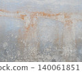 Weathered wall with peeling paint layers. 140061851