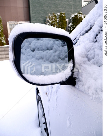 Snow piled up on the car's side mirror Snow piled up on the car's side mirror 140062016