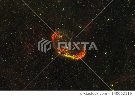 An astrophotography image capturing the Crescent Nebula, NGC 6888, glowing with orange and red gas clouds surrounded by countless stars in the deep space background. An astrophotography image capturing the Crescent Nebula, NGC 6888, glowing with orange and red gas clouds surrounded by countless stars in the deep space background. 140062119