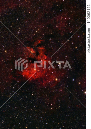 A spectacular cosmic display unfolds in the night sky, with a glowing red emission nebula, intricate dark dust lanes and countless brilliant stars. A spectacular cosmic display unfolds in the night sky, with a glowing red emission nebula, intricate dark dust lanes and countless brilliant stars. 140062121