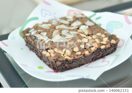 brownie or chocolate cake with almond and cashew nut topping brownie or chocolate cake with almond and cashew nut topping 140062151