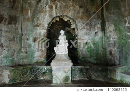 White marble female statue inside a mossy stone grotto at Quinta da Regaleira in Sintra, Portugal White marble female statue inside a mossy stone grotto at Quinta da Regaleira in Sintra, Portugal 140062853