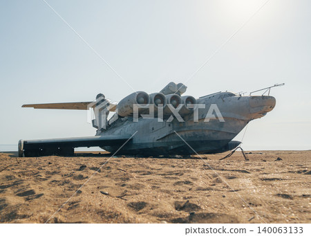 Abandoned Lun-class ekranoplan on a deserted beach near the Caspian Sea under a clear blue sky Abandoned Lun-class ekranoplan on a deserted beach near the Caspian Sea under a clear blue sky 140063133