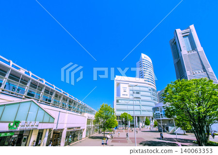 New view of Yokohama cityscape, Japan, May 30th. A view of Sakuragicho Station, trains, and Yokohama Landmark Tower against a clear blue sky. New view of Yokohama cityscape, Japan, May 30th. A view of Sakuragicho Station, trains, and Yokohama Landmark Tower against a clear blue sky. 140063353