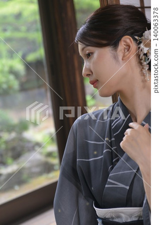 A young woman in a yukata A young woman in a yukata 140063378