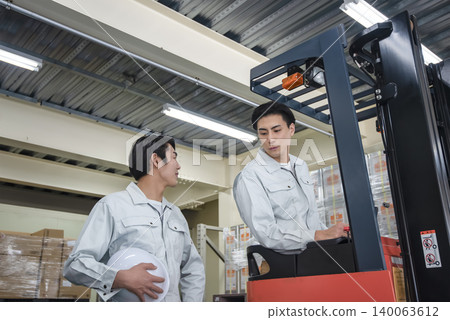 Male worker receiving safety training for forklift operation. Male worker receiving safety training for forklift operation. 140063612