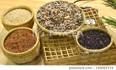 Thai variety rice paddy in bamboo tray on table 140064154
