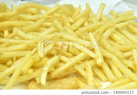 crispy snack French fries mixed with salt arranging on white paper crispy snack French fries mixed with salt arranging on white paper 140064157
