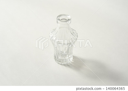 A clear glass bottle on a white background A clear glass bottle on a white background 140064365