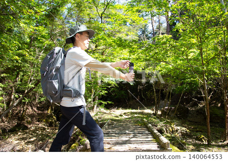 Japanese man using bear repellent spray Japanese man using bear repellent spray 140064553